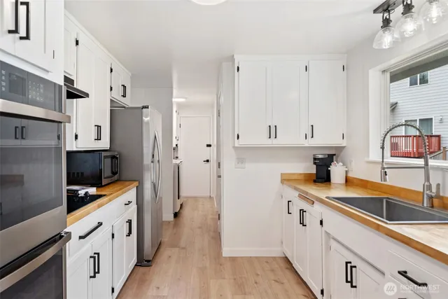 a kitchen with stainless steel appliances a sink stove and cabinets