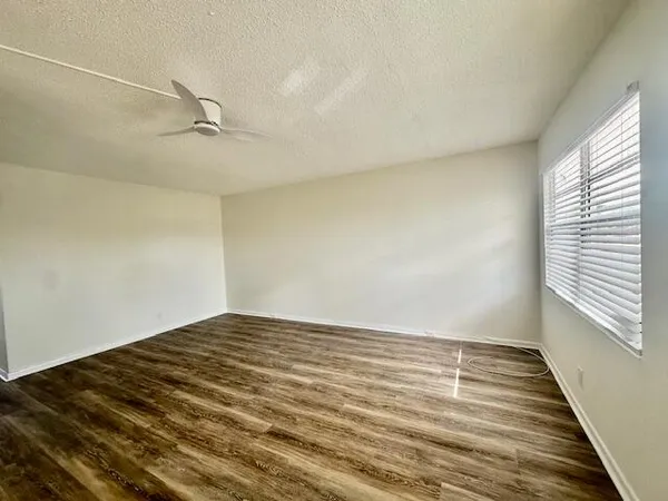 a view of room with window and wooden floor