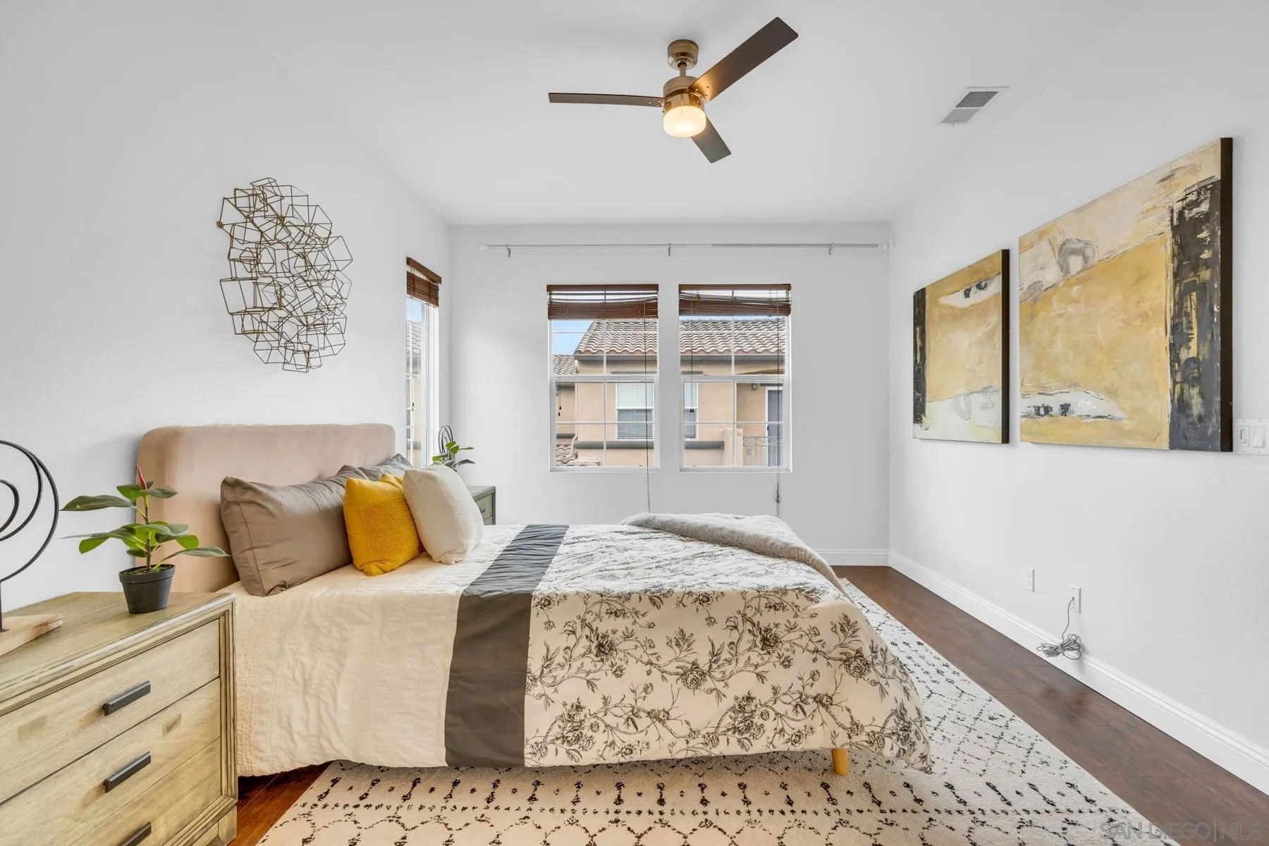 649 Sumner Way, Unit 6 Oceanside, CA 92058 - Photo 17 of 30 a bedroom with a bed and wooden floor