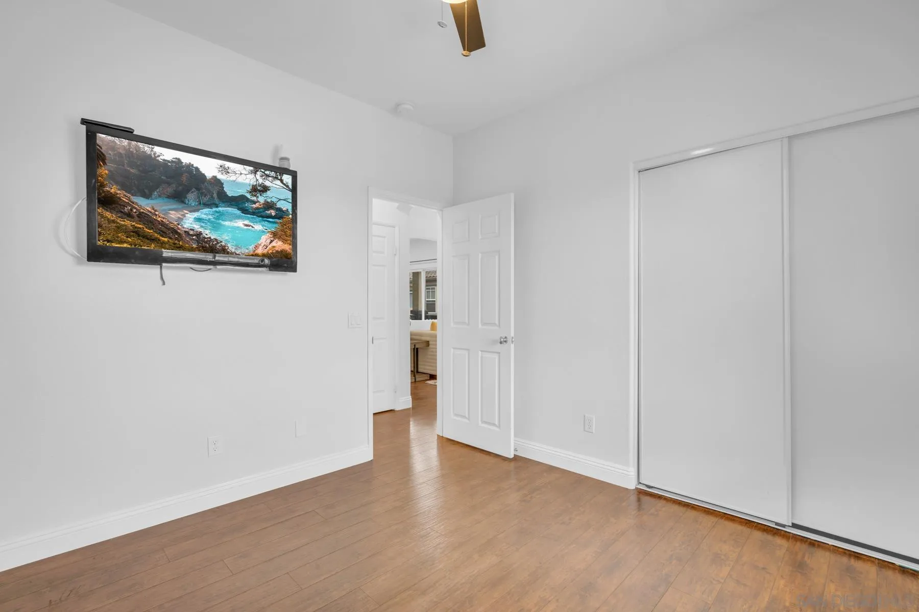 649 Sumner Way, Unit 6 Oceanside, CA 92058 - Photo 19 of 30 a view of an empty room with wooden floor