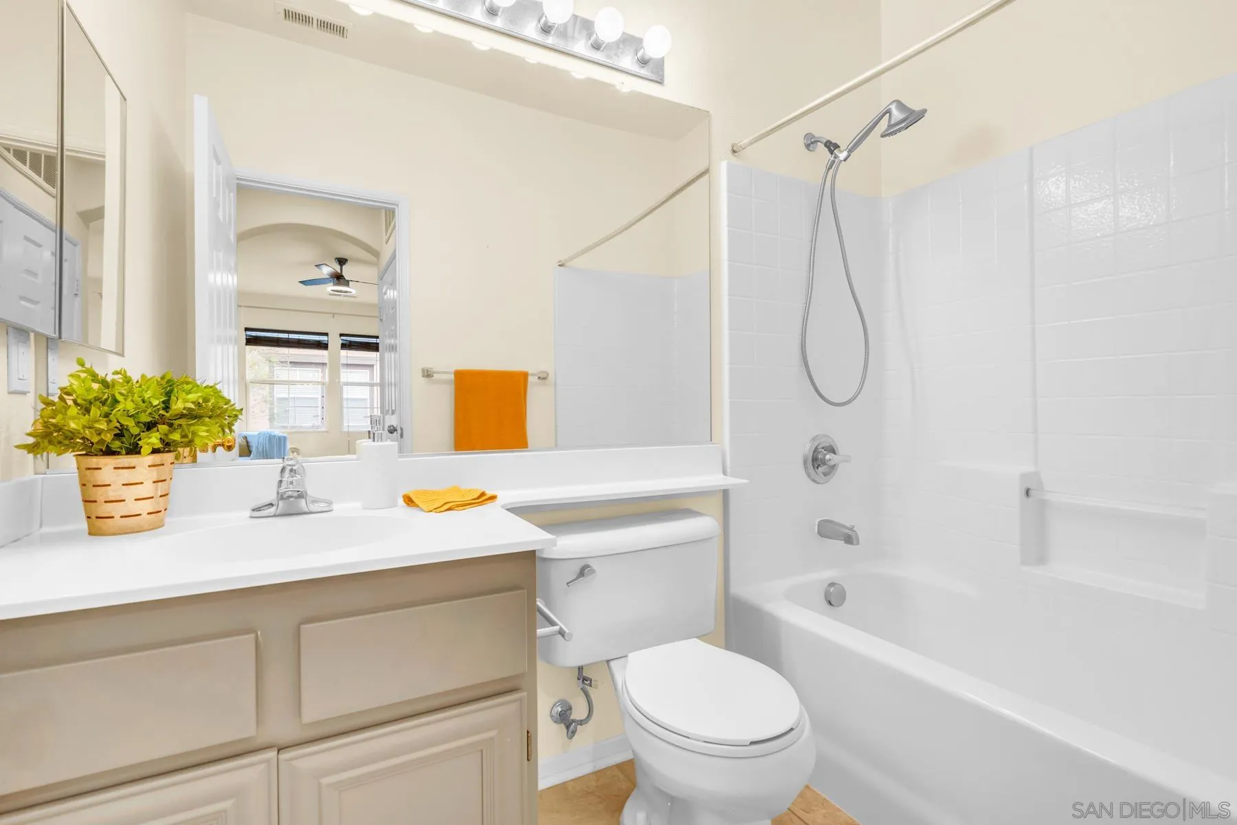 649 Sumner Way, Unit 6 Oceanside, CA 92058 - Photo 20 of 30 a bathroom with a sink vanity mirror bathtub and toilet