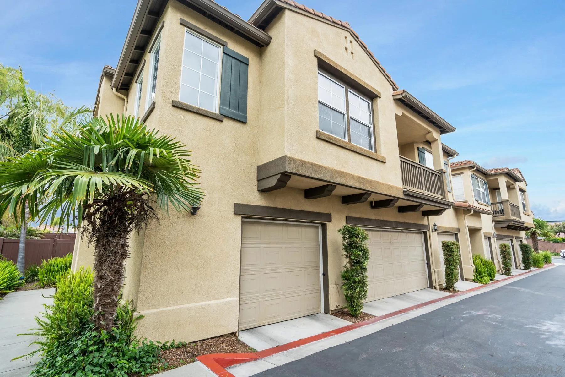 649 Sumner Way, Unit 6 Oceanside, CA 92058 - Photo 25 of 30 a front view of a house with garage and plants