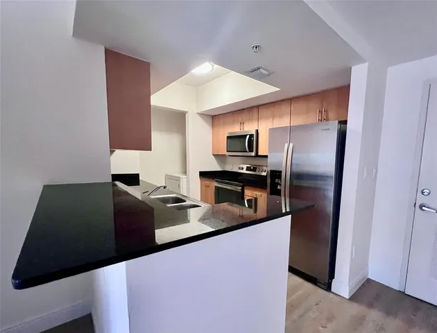a kitchen with stainless steel appliances a refrigerator and a stove