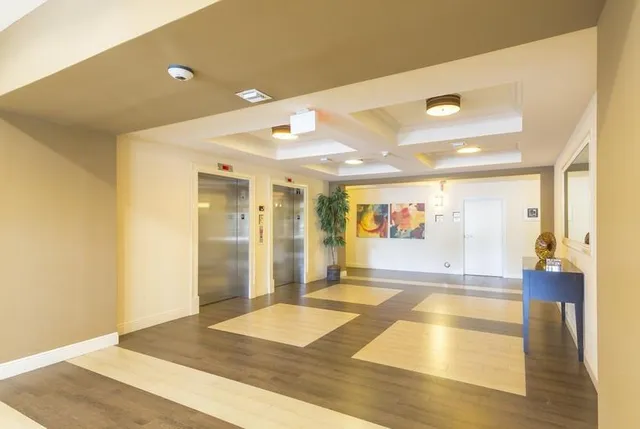 a view of a hallway with wooden floor