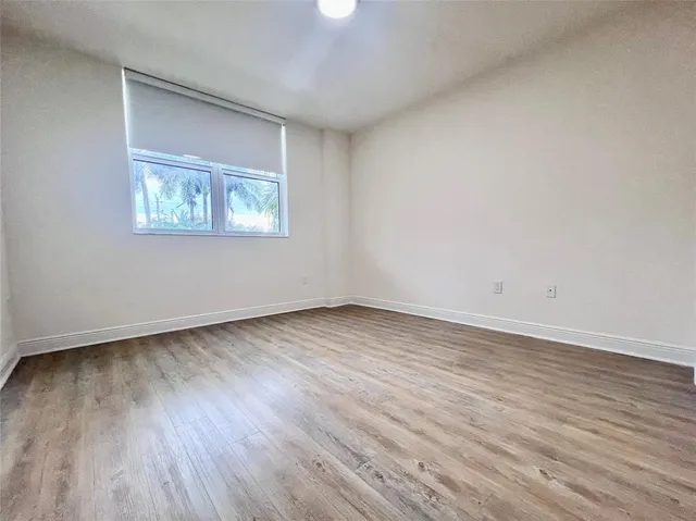a view of an empty room and wooden floor
