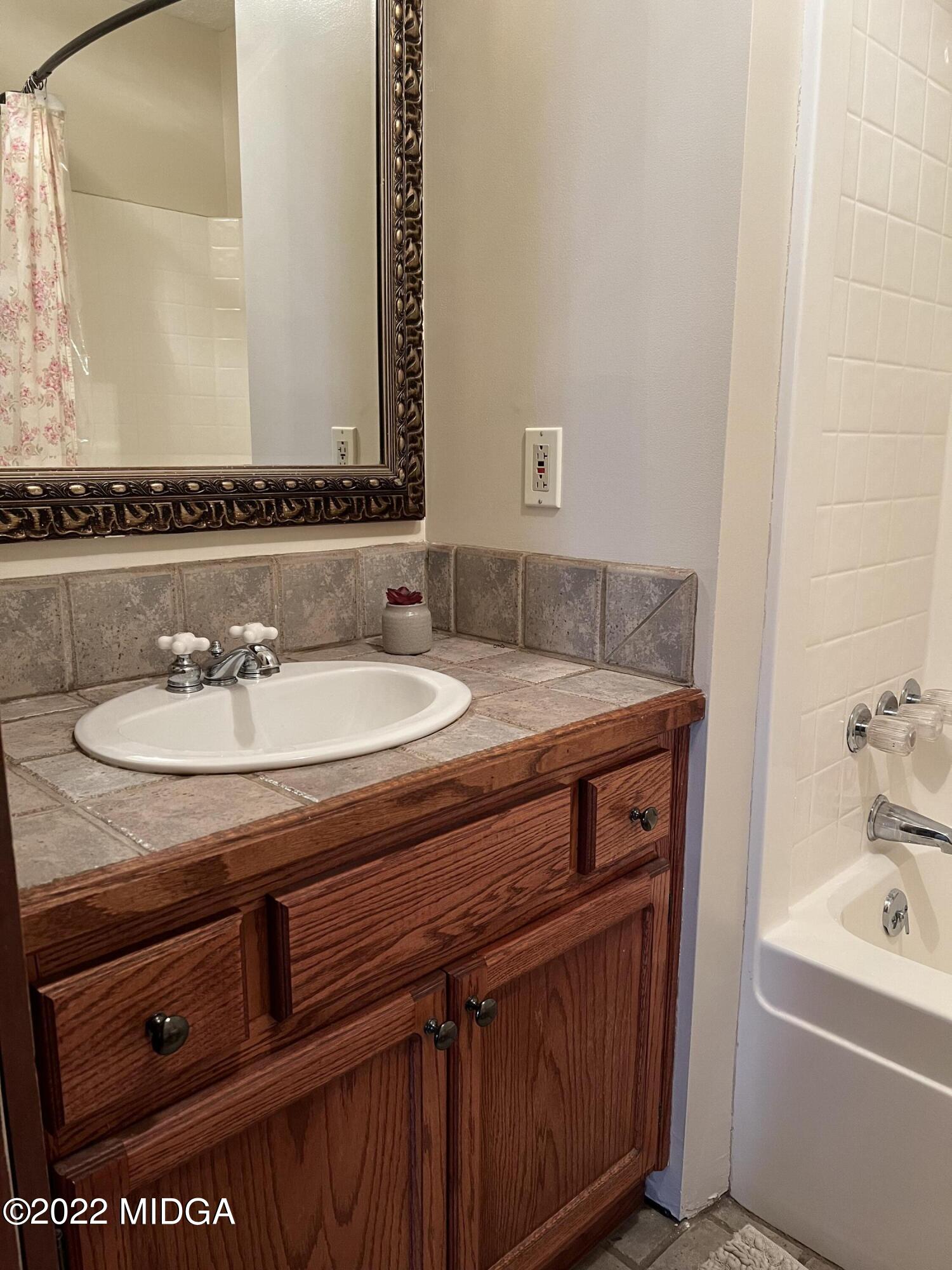436 Barrow Road Reynolds, GA 31076 - Photo 29 of 91 a bathroom with a sink and a mirror