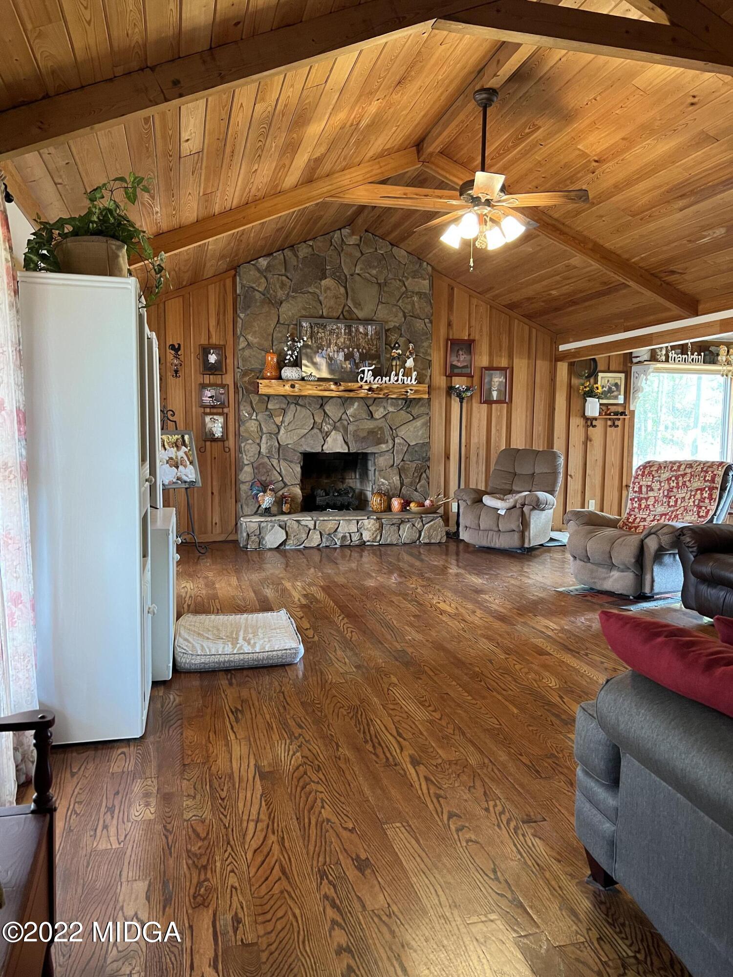 436 Barrow Road Reynolds, GA 31076 - Photo 3 of 91 a living room with furniture a fireplace and a table
