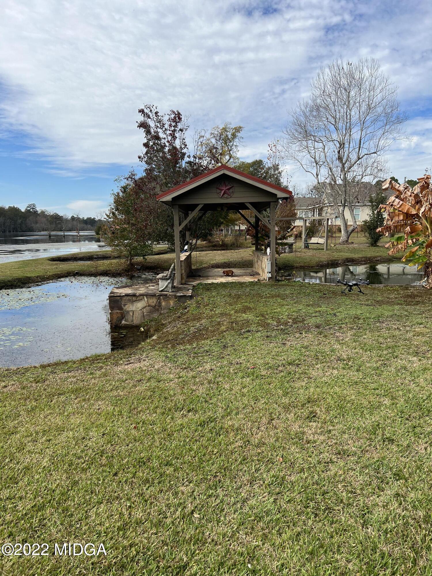 436 Barrow Road Reynolds, GA 31076 - Photo 72 of 91 a view of a lake with a car parked in front of it