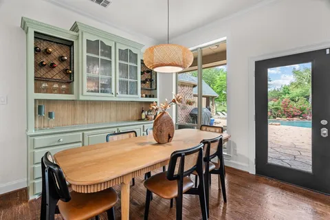 a table and chairs in a room next to a window