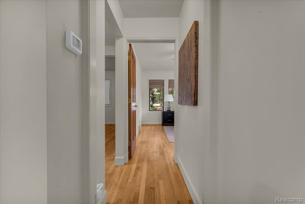 1156 Seneca Road Lake Orion, MI 48362 - Photo 21 of 50 Hallway featuring light wood-type flooring and baseboards
