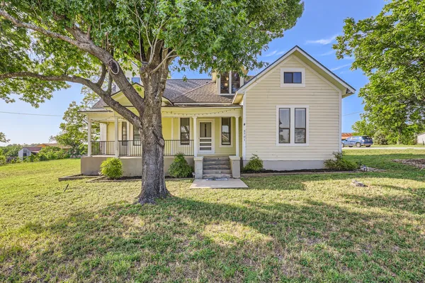 a view of a house with yard and sitting area