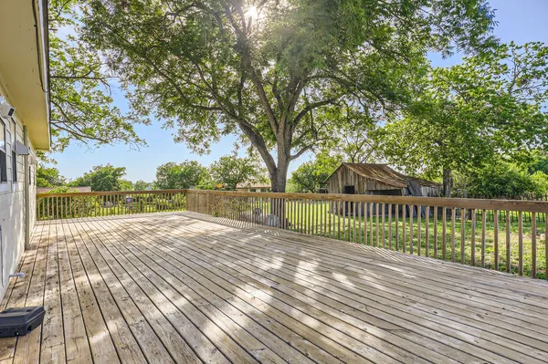 a view of balcony with wooden floor and fence