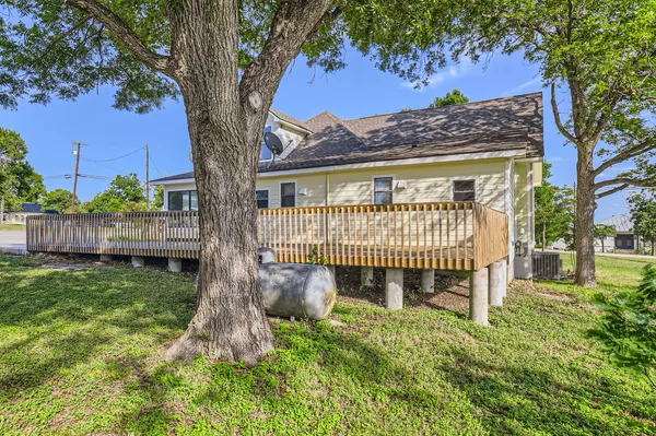 a view of a house with a small yard and wooden fence