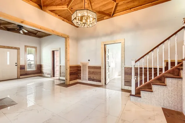a view of a livingroom with wooden floor and stairs