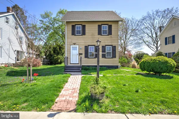 a front view of house with yard and green space