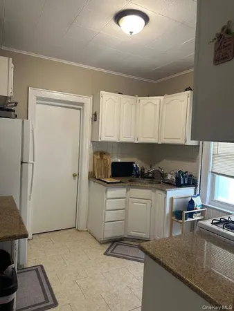 a kitchen with a refrigerator and a stove top oven
