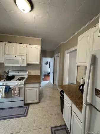 a kitchen with a stove top oven and refrigerator