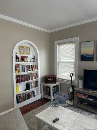 a view of a livingroom with furniture and a window