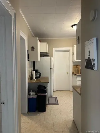 a kitchen with a refrigerator and a stove