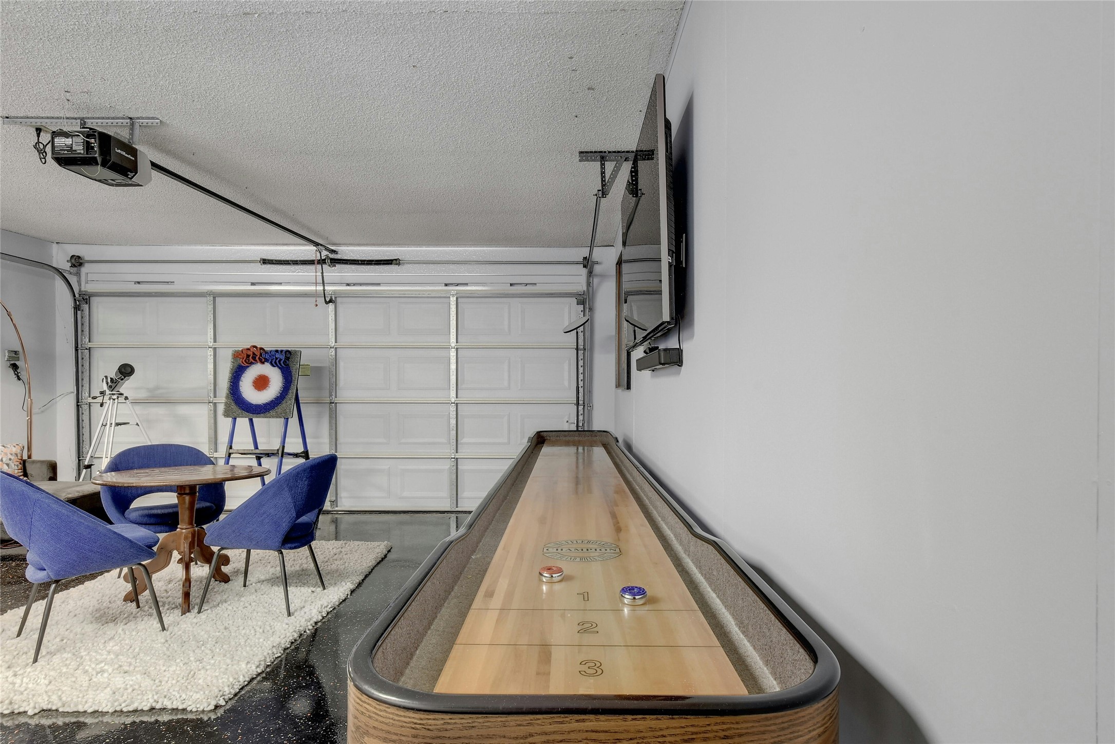 1503 Terrapin Court, Unit B Austin, TX 78746 - Photo 13 of 35 Playroom featuring a textured ceiling and a garage