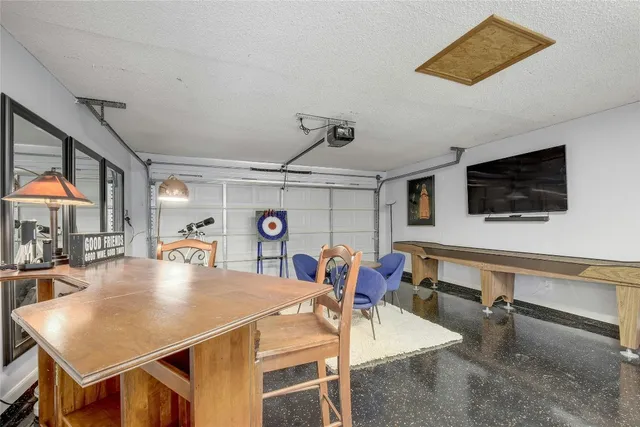 a view of a dining room with furniture and a flat screen tv