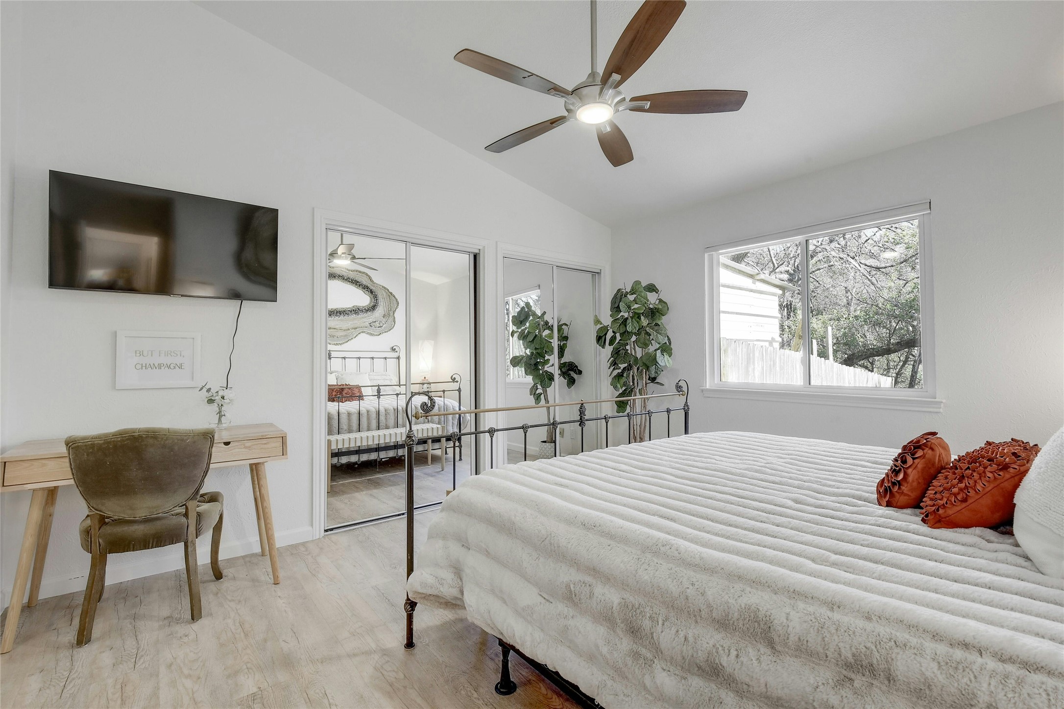 1503 Terrapin Court, Unit B Austin, TX 78746 - Photo 16 of 35 Bedroom with vaulted ceiling, light wood finished floors, and ceiling fan
