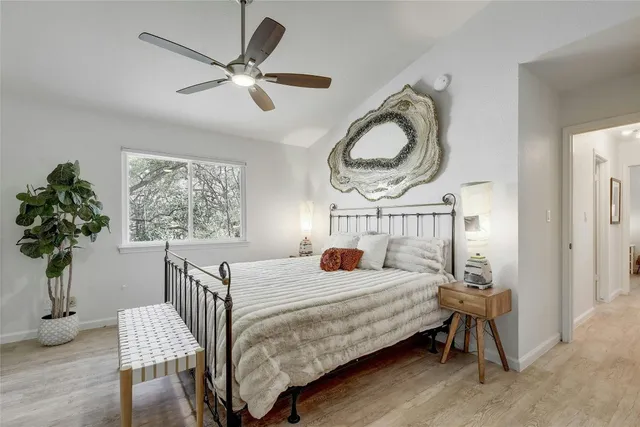 a bedroom with a bed and a chandelier