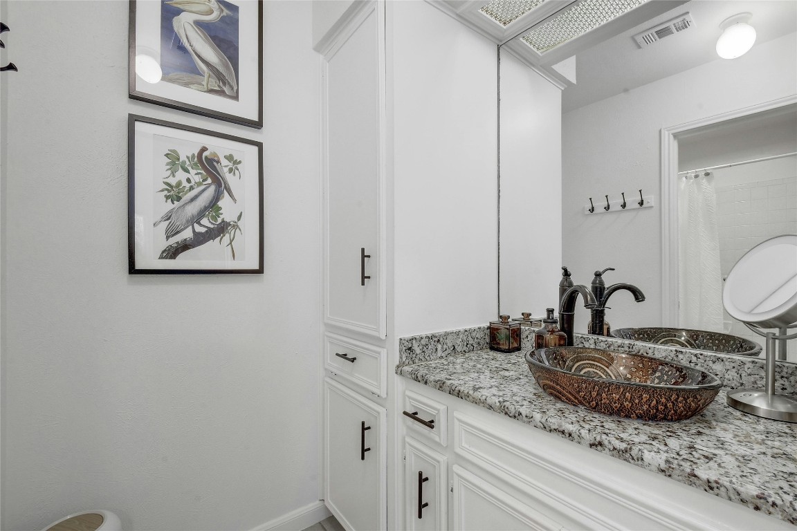 1503 Terrapin Court, Unit B Austin, TX 78746 - Photo 18 of 28 a bathroom with a granite countertop sink and a mirror
