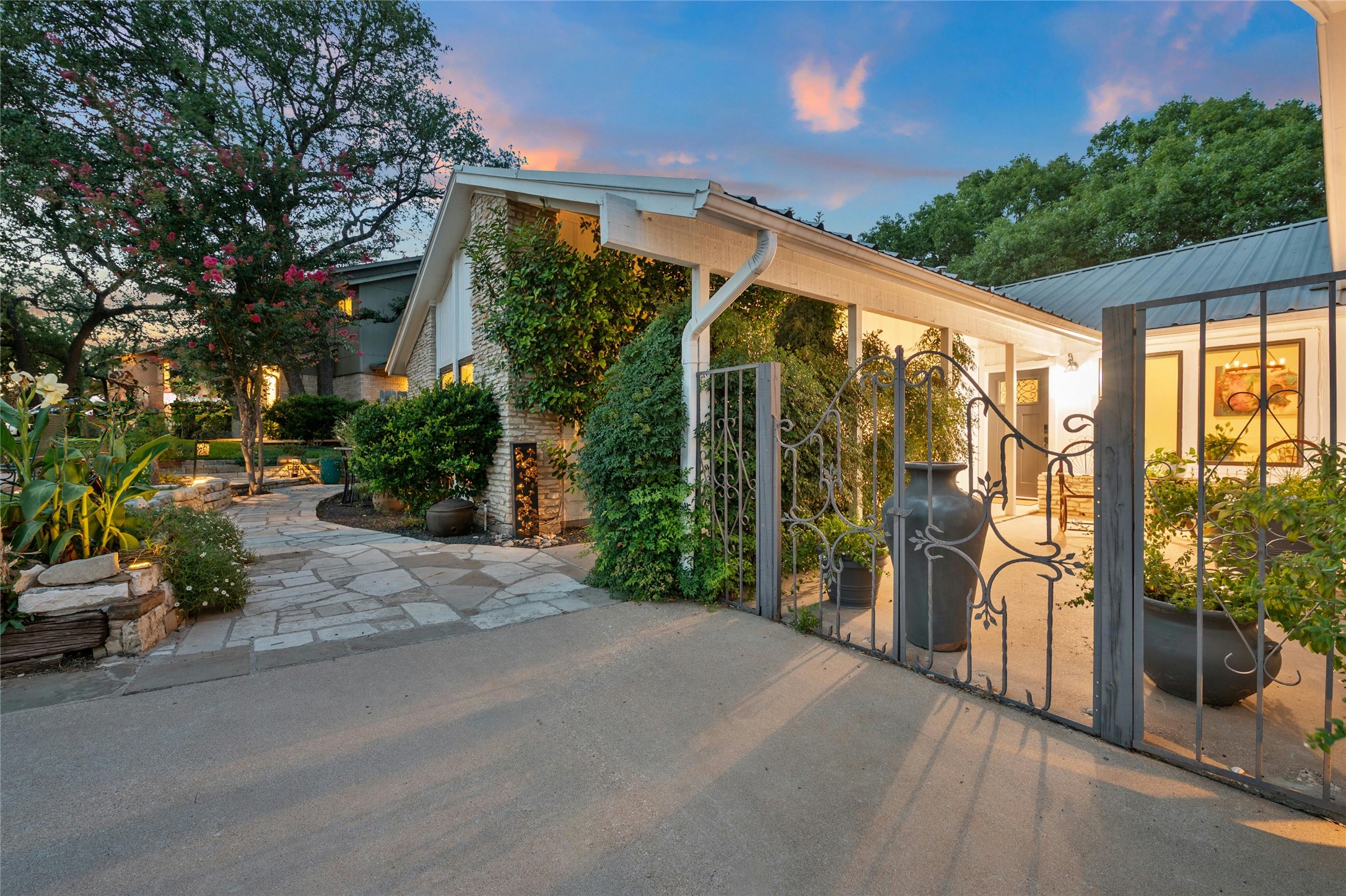 1503 Terrapin Court, Unit B Austin, TX 78746 - Photo 2 of 35 View of home's exterior featuring a metal roof and a gate