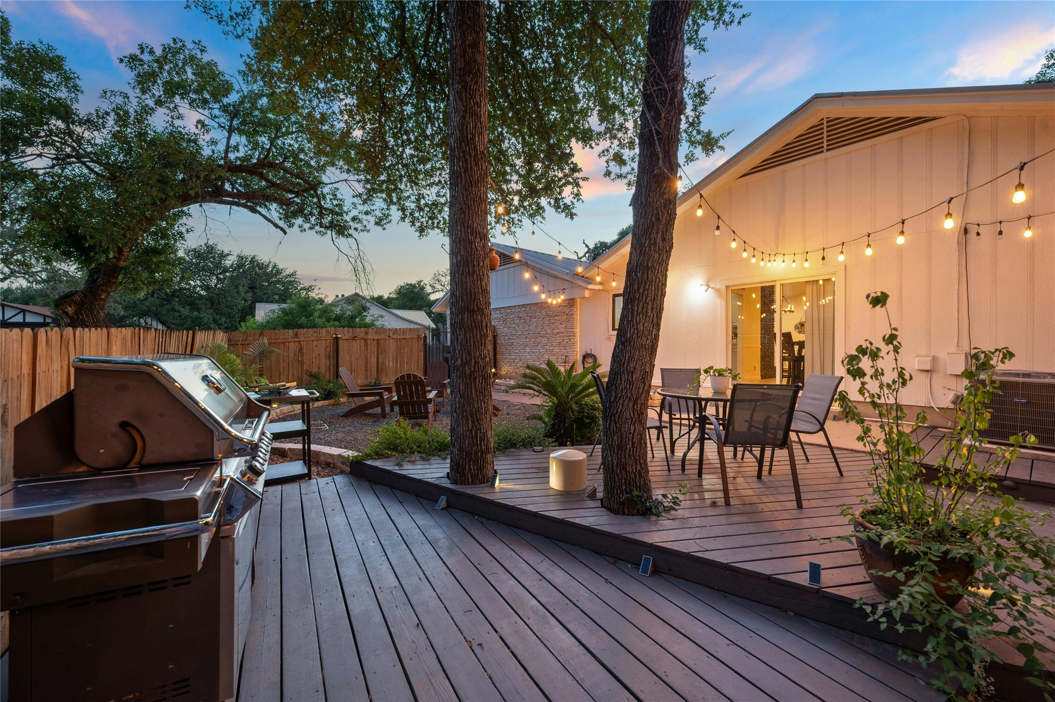 1503 Terrapin Court, Unit B Austin, TX 78746 - Photo 25 of 35 Wooden terrace featuring outdoor dining space, grilling area, and a fenced backyard
