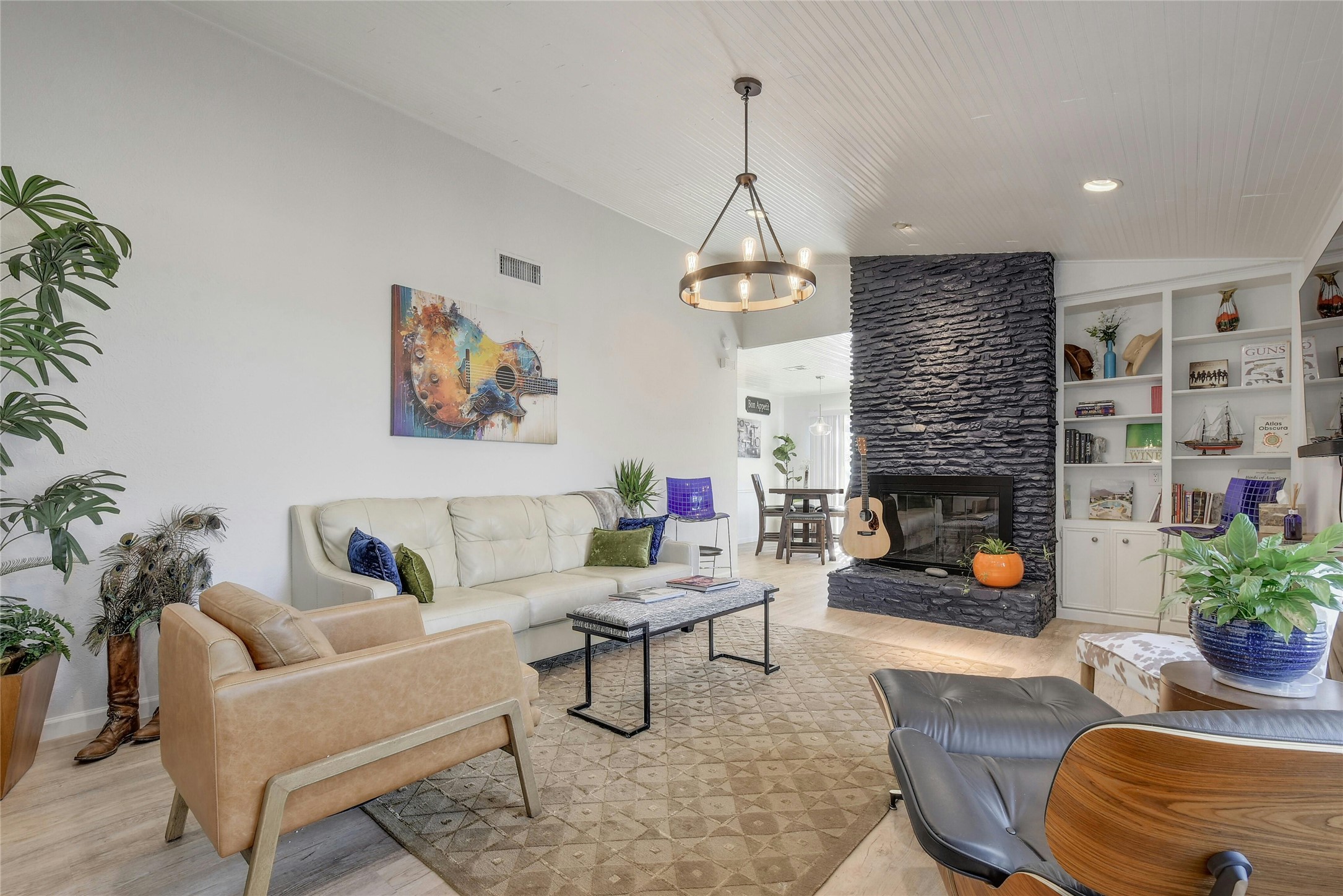 1503 Terrapin Court, Unit B Austin, TX 78746 - Photo 3 of 35 Living room with vaulted ceiling, light wood-style floors, a stone fireplace, and built in features
