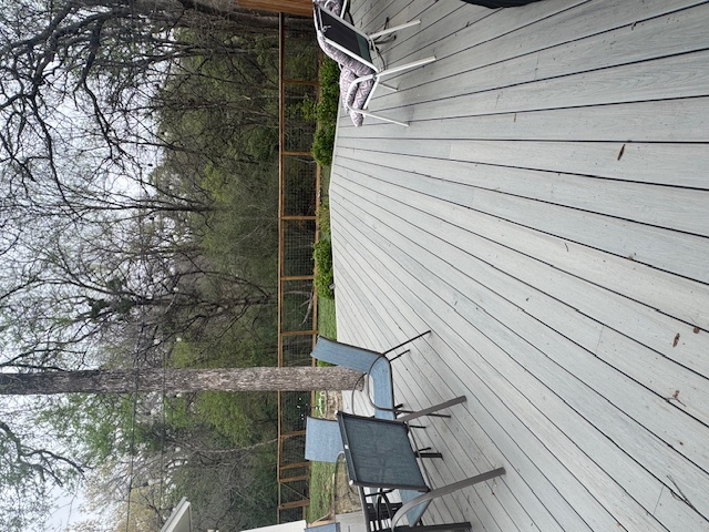 1503 Terrapin Court, Unit B Austin, TX 78746 - Photo 32 of 35 Wooden terrace with outdoor dining area