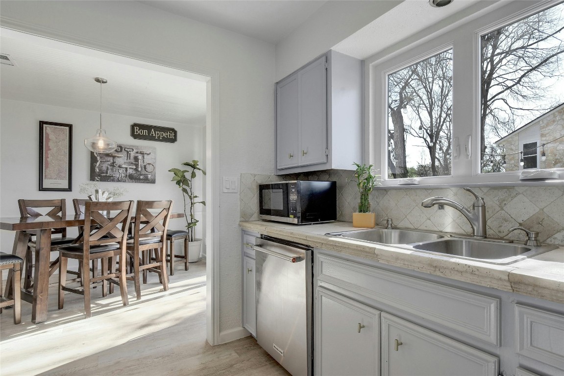 1503 Terrapin Court, Unit B Austin, TX 78746 - Photo 9 of 28 a kitchen with stainless steel appliances granite countertop a stove a sink and a microwave
