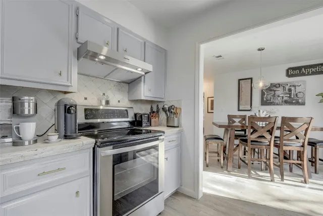a kitchen with stainless steel appliances granite countertop a sink and cabinets