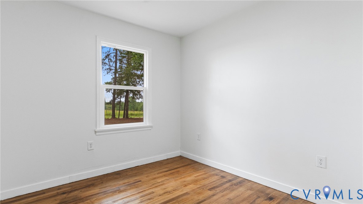 11550 Lunenburg County Road Keysville, VA 23947 - Photo 11 of 48 Wood-finish flooring, white walls, white trim, and