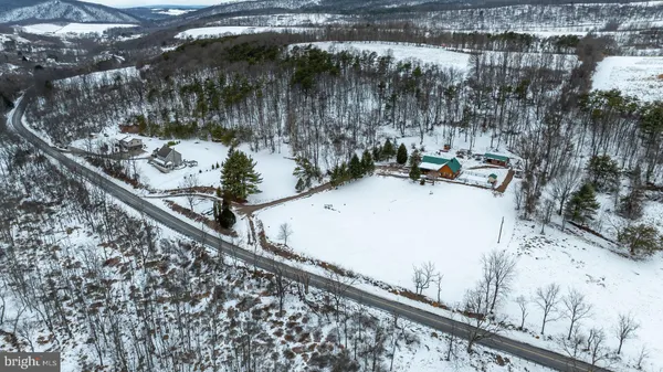 a view of a yard with wooden fence