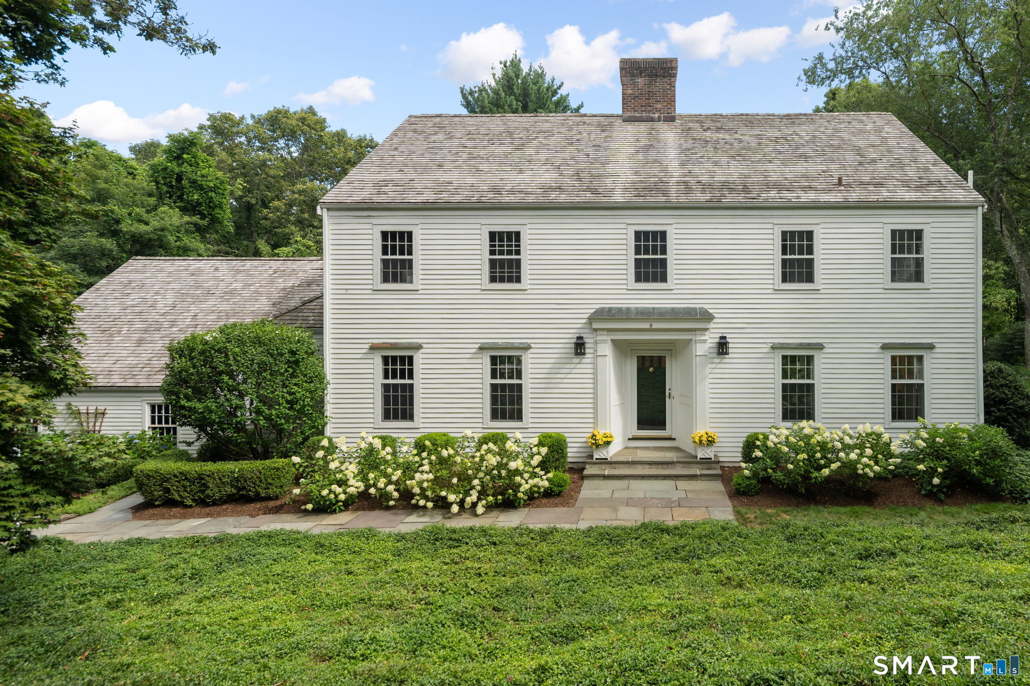 45 Ryders Lane Wilton, CT 06897 - Photo 1 of 37 a front view of a house with a yard