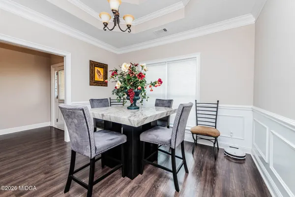 a view of a dining room with furniture and wooden floor