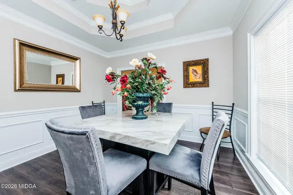 a view of a dining room with furniture and wooden floor