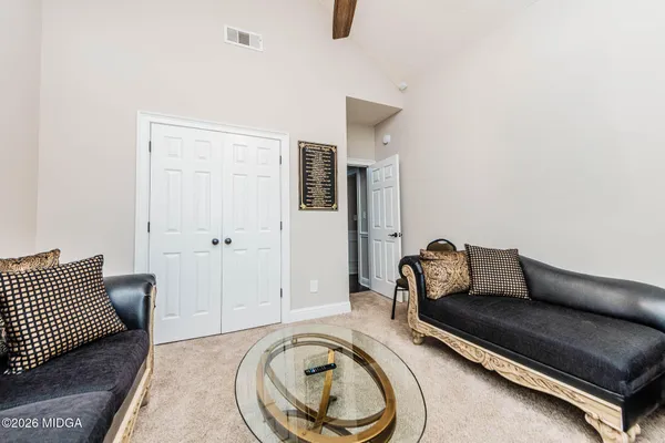 a living room with furniture and a rug