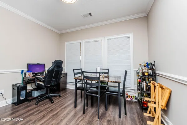 a view of a dining room with furniture and wooden floor