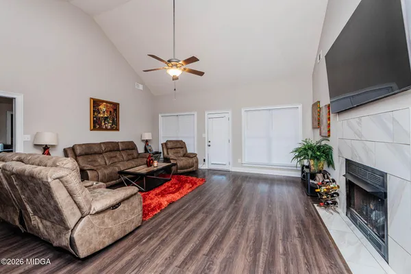 a living room with furniture fireplace and wooden floor