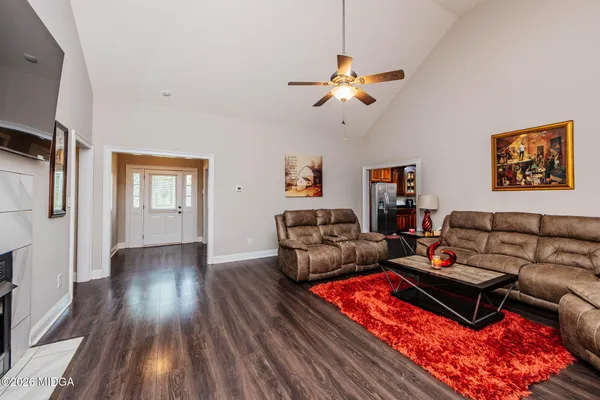 a living room with furniture and wooden floor