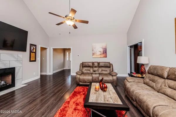 a living room with furniture and a fireplace