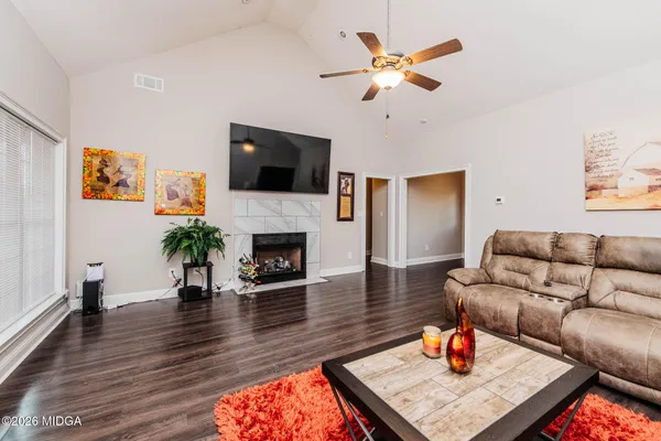 a living room with furniture fireplace and a flat screen tv
