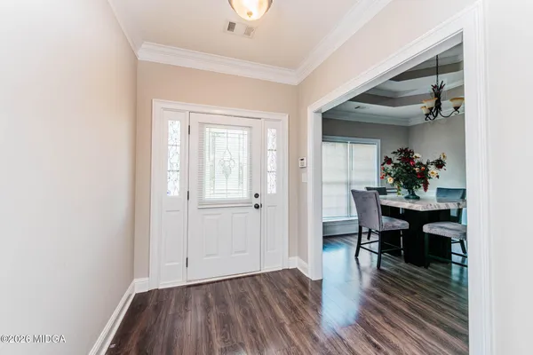a view of a dining room with furniture and wooden floor