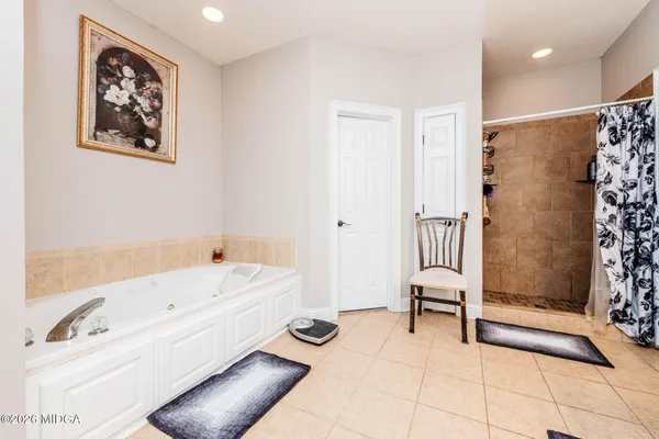 a bathroom with a bathtub and a shower