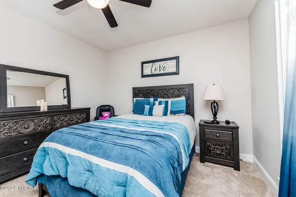 a bedroom with a bed and a dresser