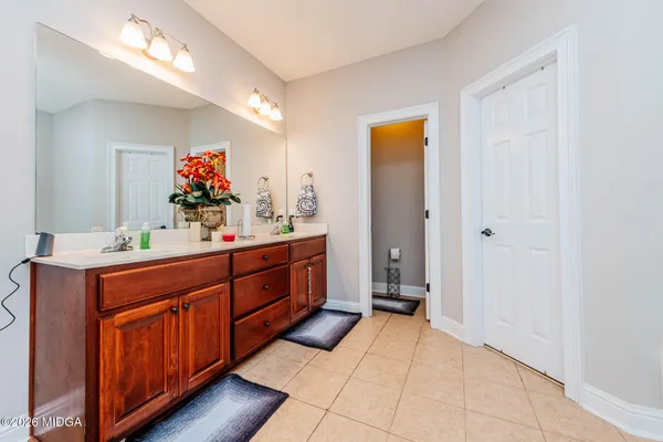 a spacious bathroom with a double vanity sink and a mirror