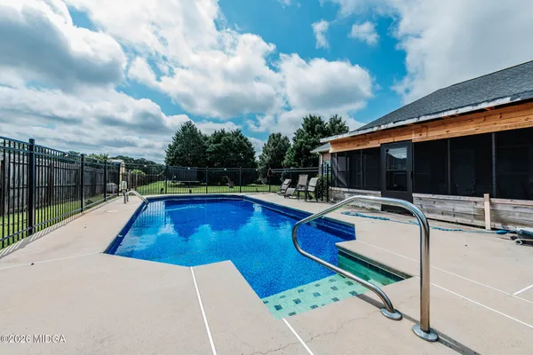 a view of swimming pool with lounge chair